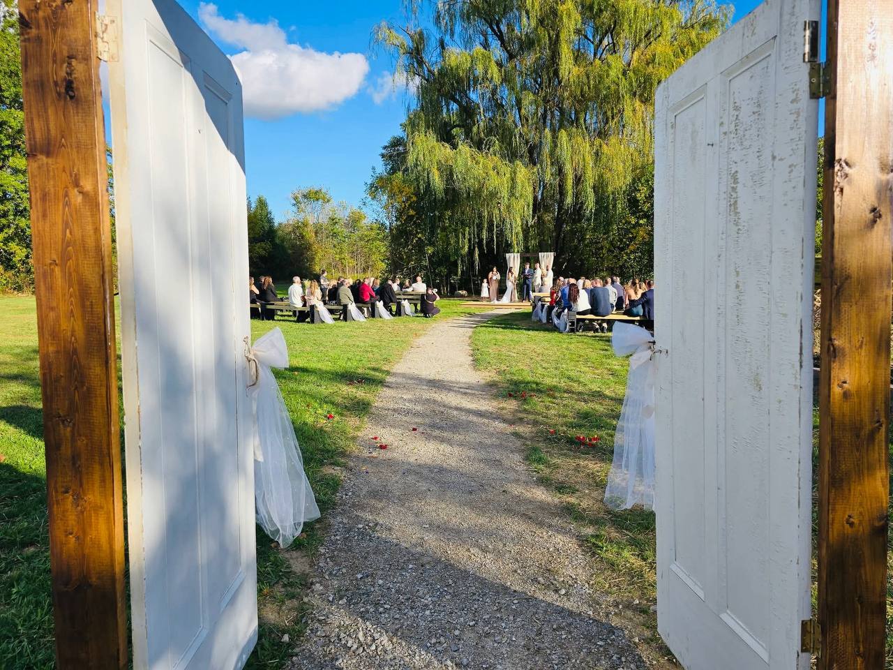 Wedding ceremony view through the white doors
